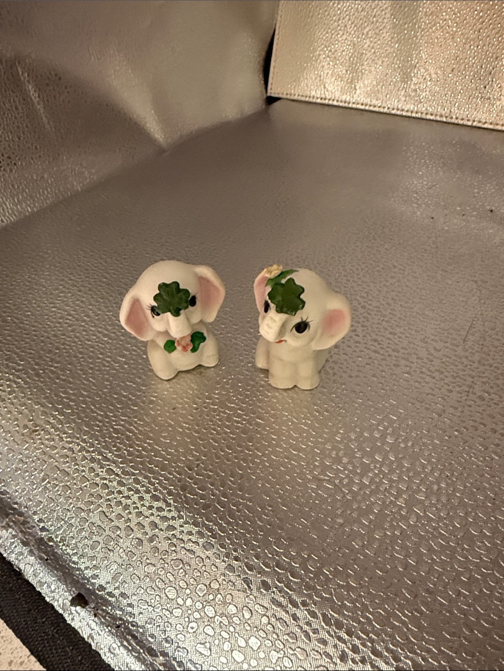 Vintage Lefton hand painted baby elephants holding four leaf clovers.